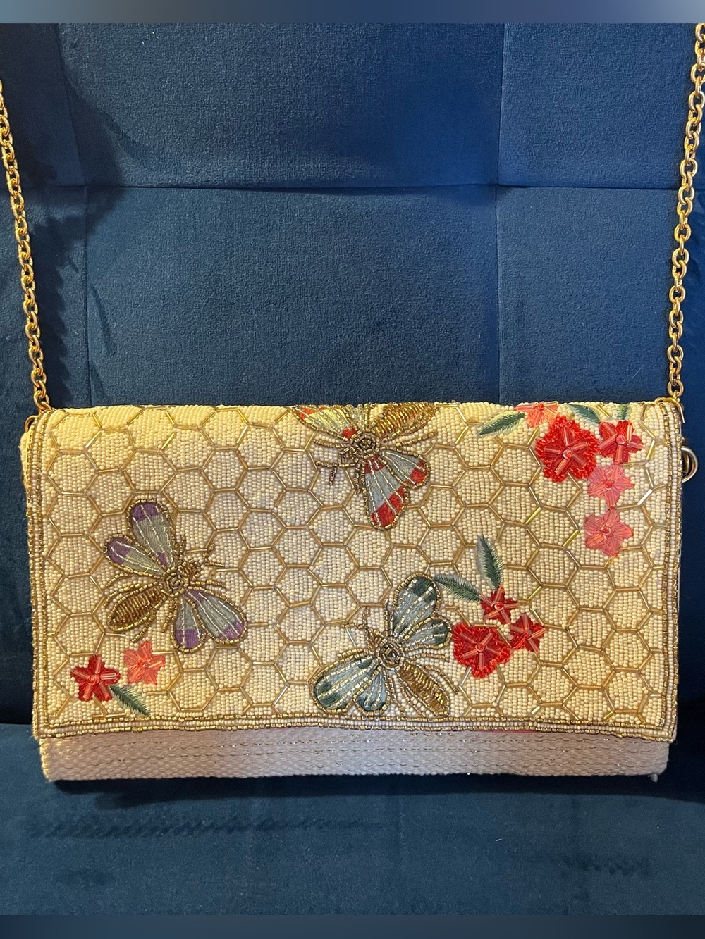 America & Beyond beaded bag with bees, flowers, and honeycomb motif.